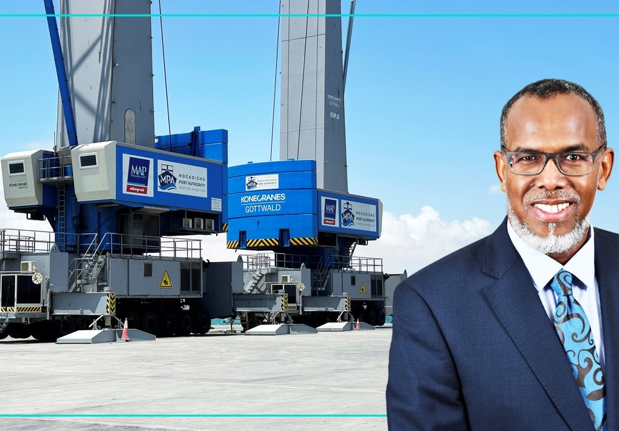 Two mobile harbour cranes at the Port of Mogadishu alongside a portrait of Ambassador Mohamed Ali Nur, Director General of the Mogadishu Port Authority.